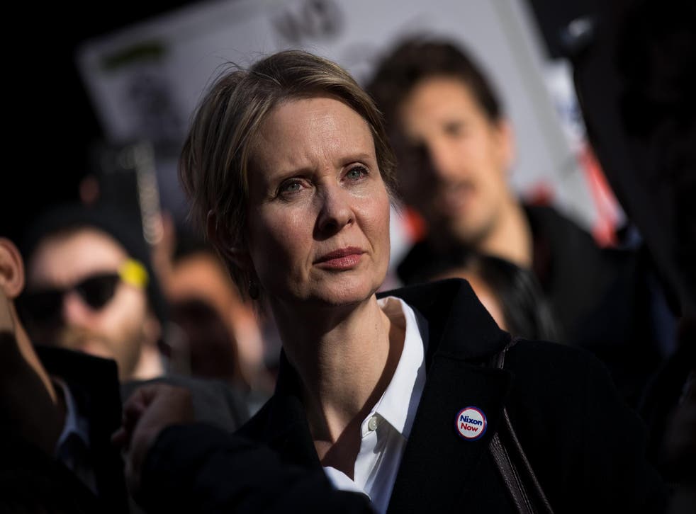 New York gubernatorial candidate Cynthia Nixon stands with activists as they rally against financial institutions' support of private prisons and immigrant detention centers, as part of a May Day protest near Wall Street in Lower Manhattan, 1 May 2018 in