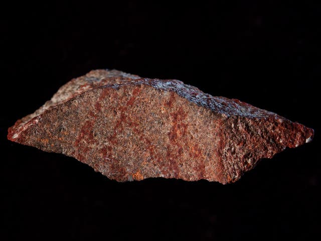 The drawing found in Blombos Cave, made with ochre pencil on silcrete stone