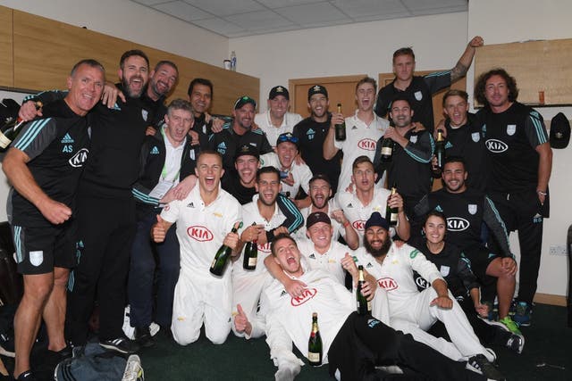 Surrey players and staff celebrate in the dressing room
