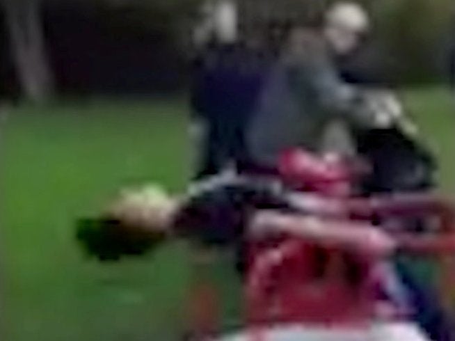 Still from video showing the 11-year-old being spun on a roundabout at high speed
