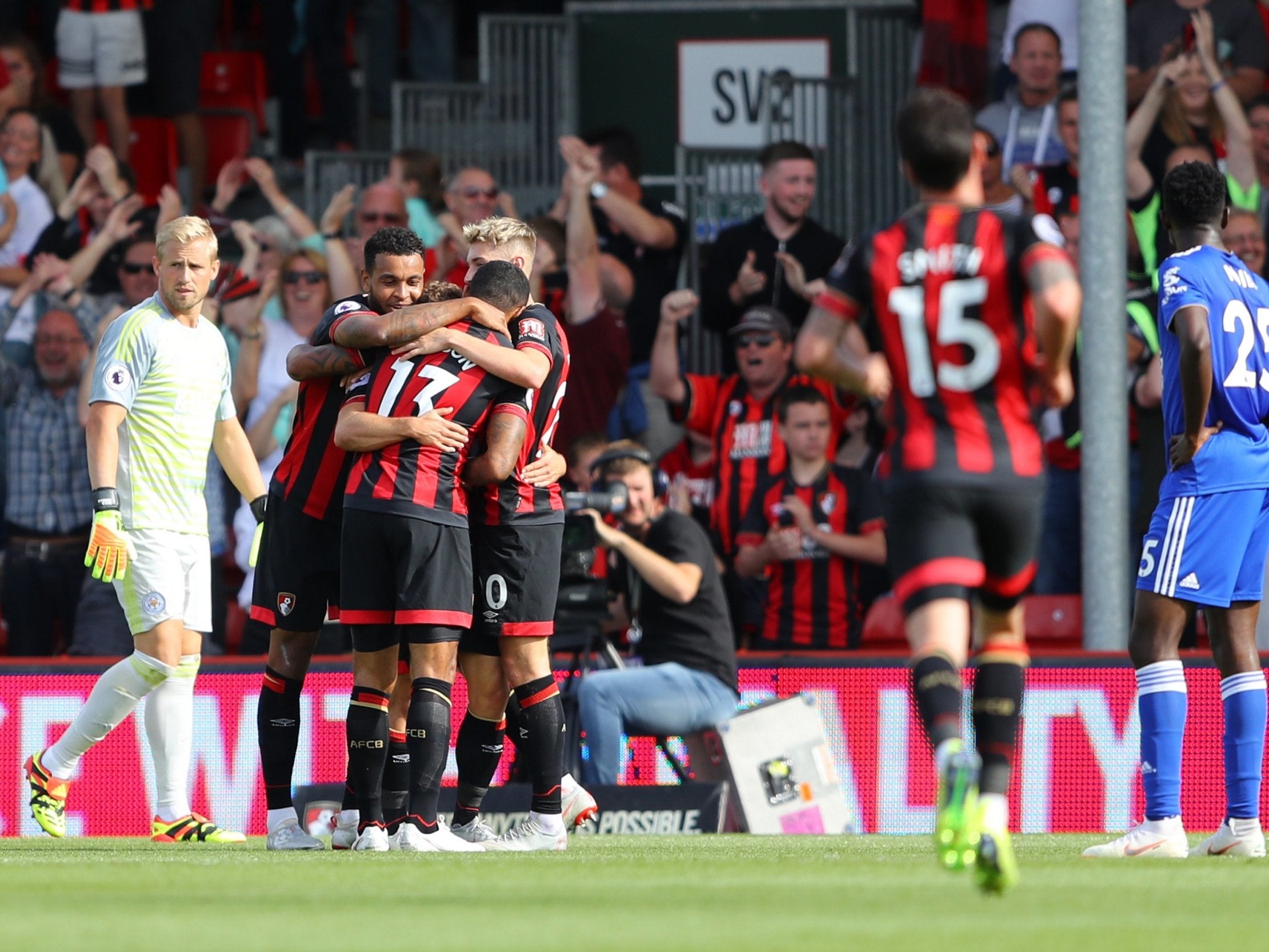 Ryan Fraser is swamped by his Bourneouth teammates after scoring against Leicester