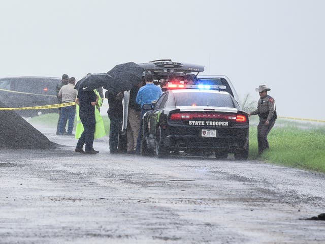 Law enforcement officers at the scene where the fourth victim's body was found on Saturday