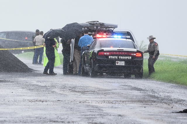 Law enforcement officers at the scene where the fourth victim's body was found on Saturday