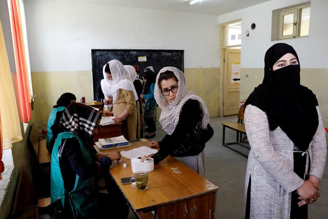 Afghan women arrive at a voter registration centre to register for the upcoming parliamentary and district council elections in Kabul, Afghanistan