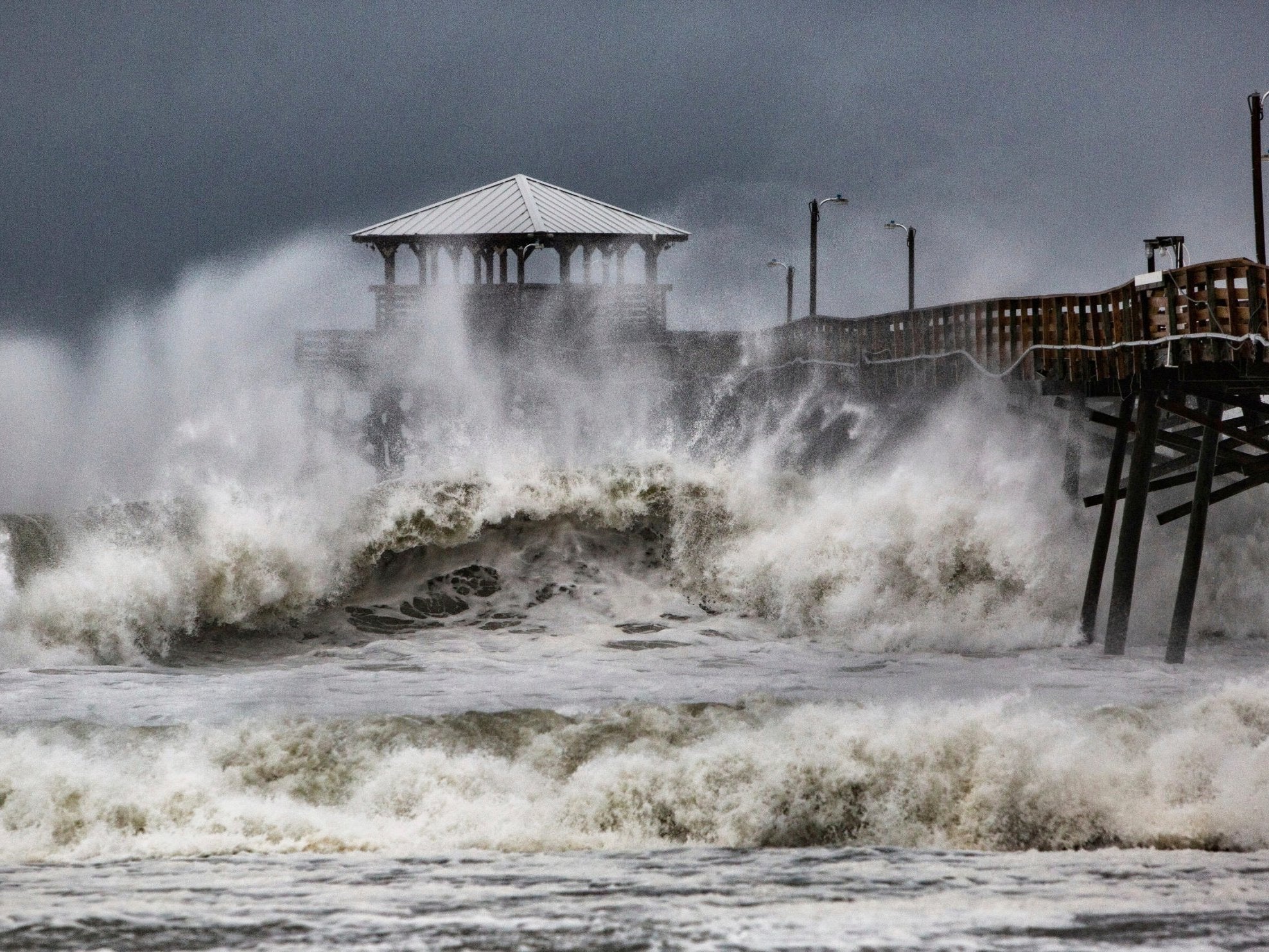 Waves slam the Oceana Pier and Pier House Restaurant in Atlantic Beach, North Carolina