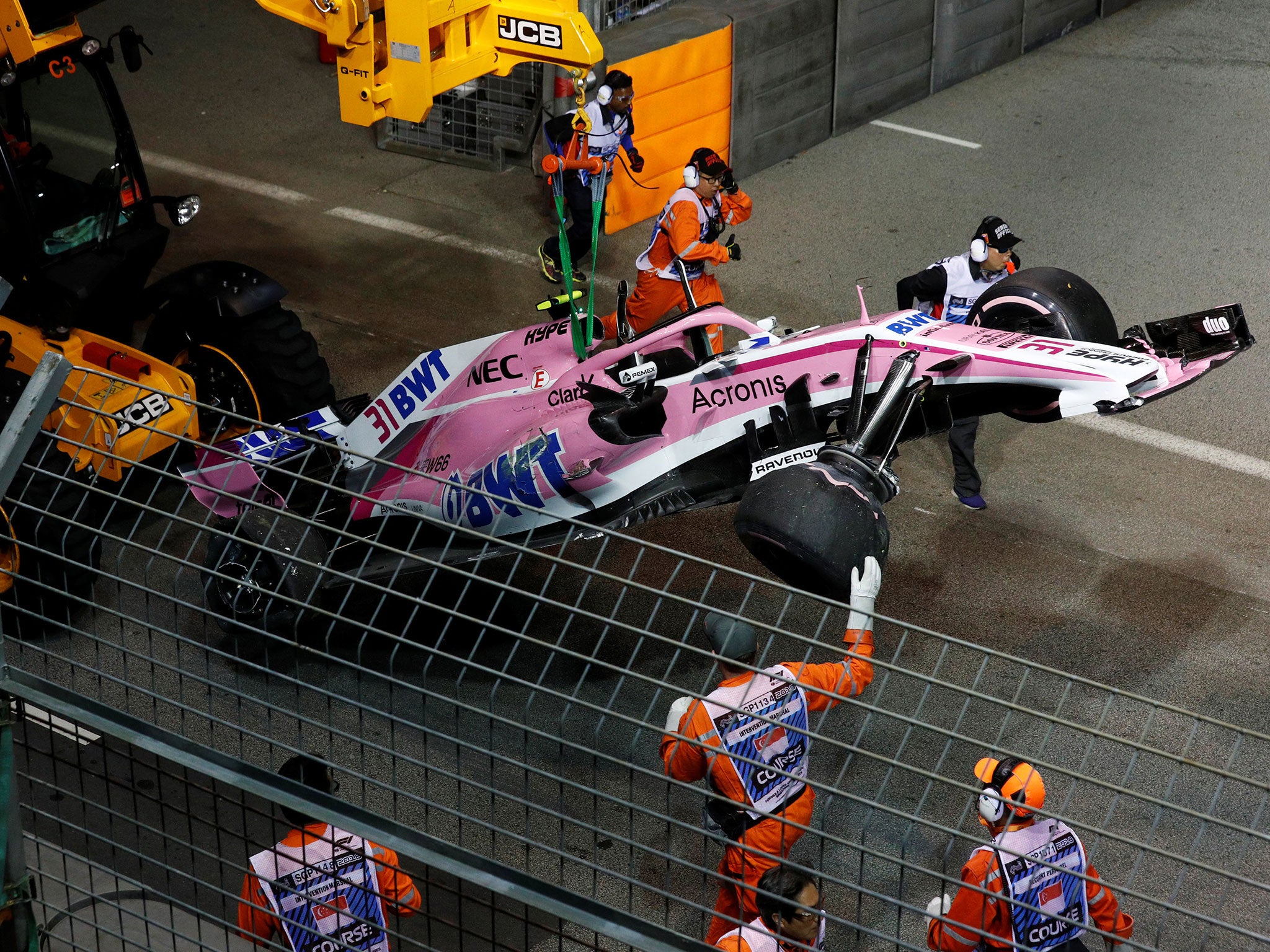 Esteban Ocon's Force India is removed from the track after his first-lap accident