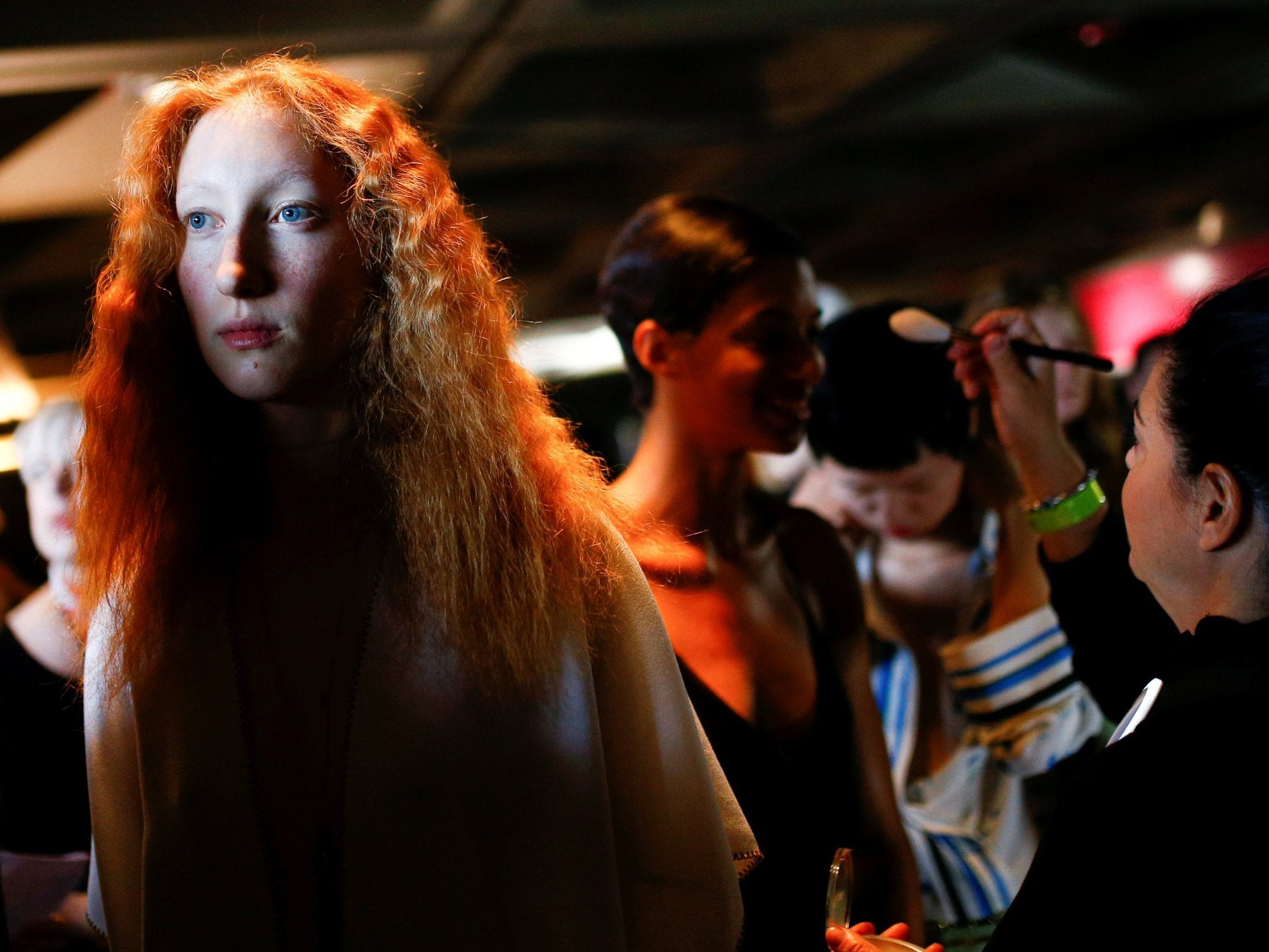 Models prepare backstage of the Roland Mouret catwalk show at the National Theatre