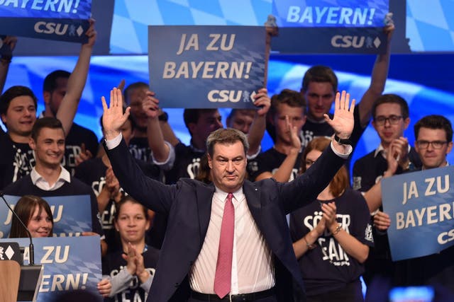 Bavaria's governor, Markus Soeder, waves after his speech at the Christian Social Union party congress in Munich