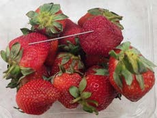 Police charge woman over strawberries spiked with needles 