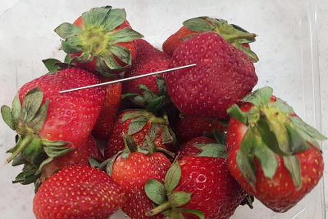 A woman has been charged after the nationwide alert over fruit laced with needles