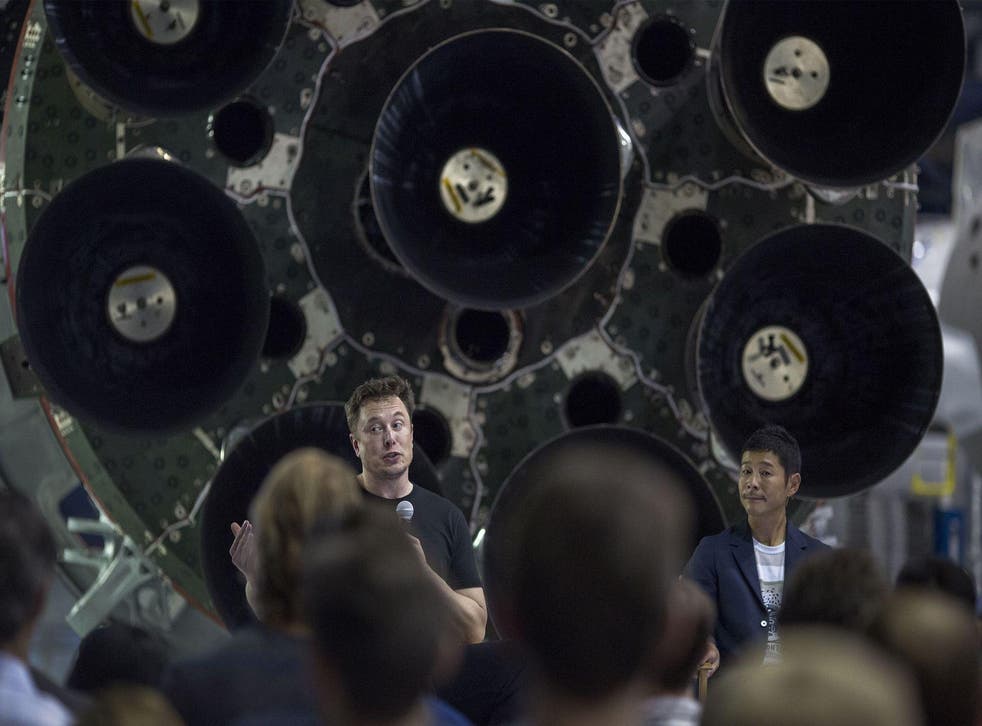 Elon Musk and Japanese billionaire Yusaku Maezawa speak before a Falcon 9 rocket during the announcement that Maezawa will be the first private passenger who will fly around the Moon aboard the SpaceX BFR launch vehicle