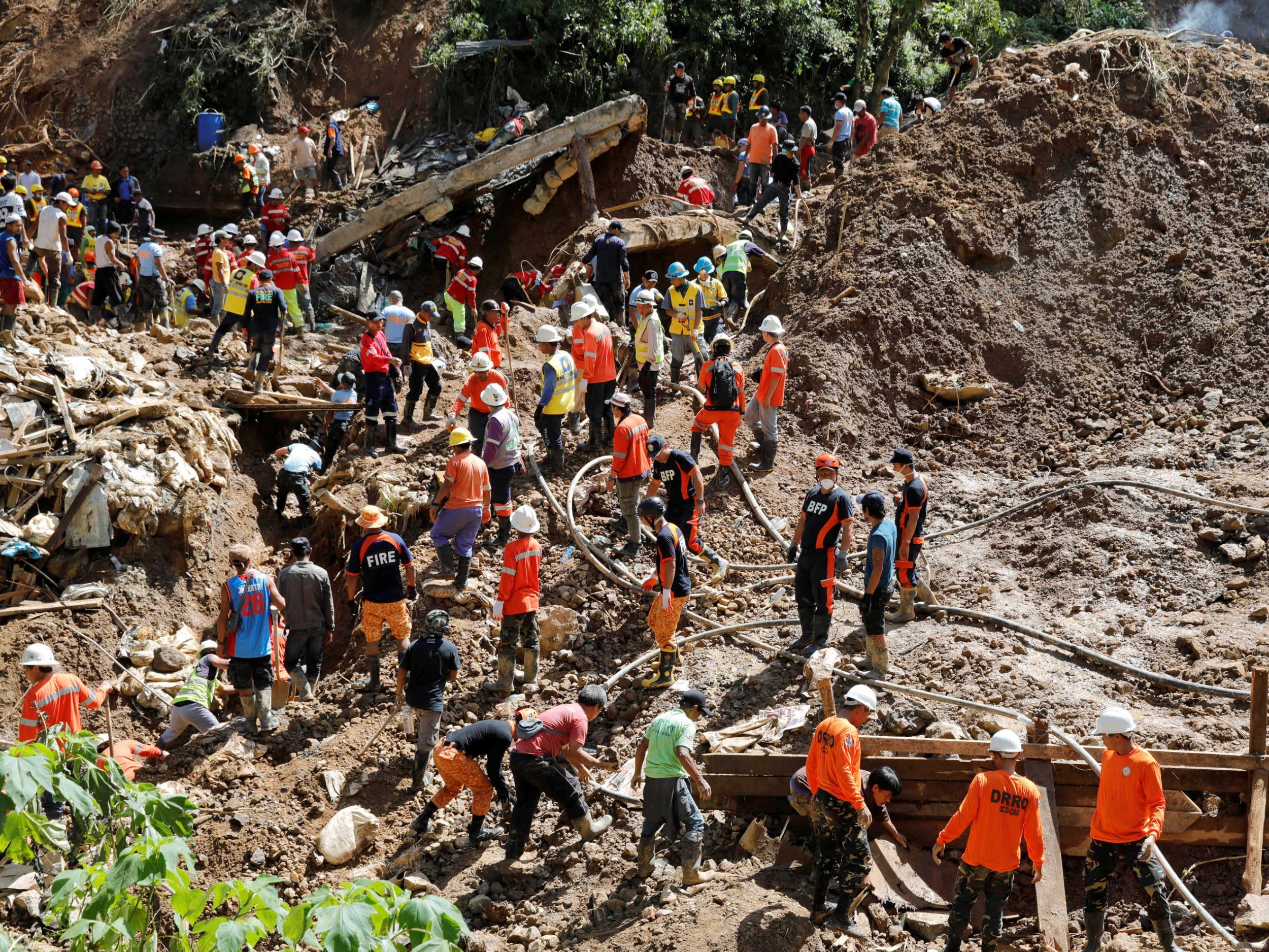 Rescuers continue their search for missing miners in a landslide caused by Typhoon Mangkhut at a small-scale mining camp in Itogon (Reuters)