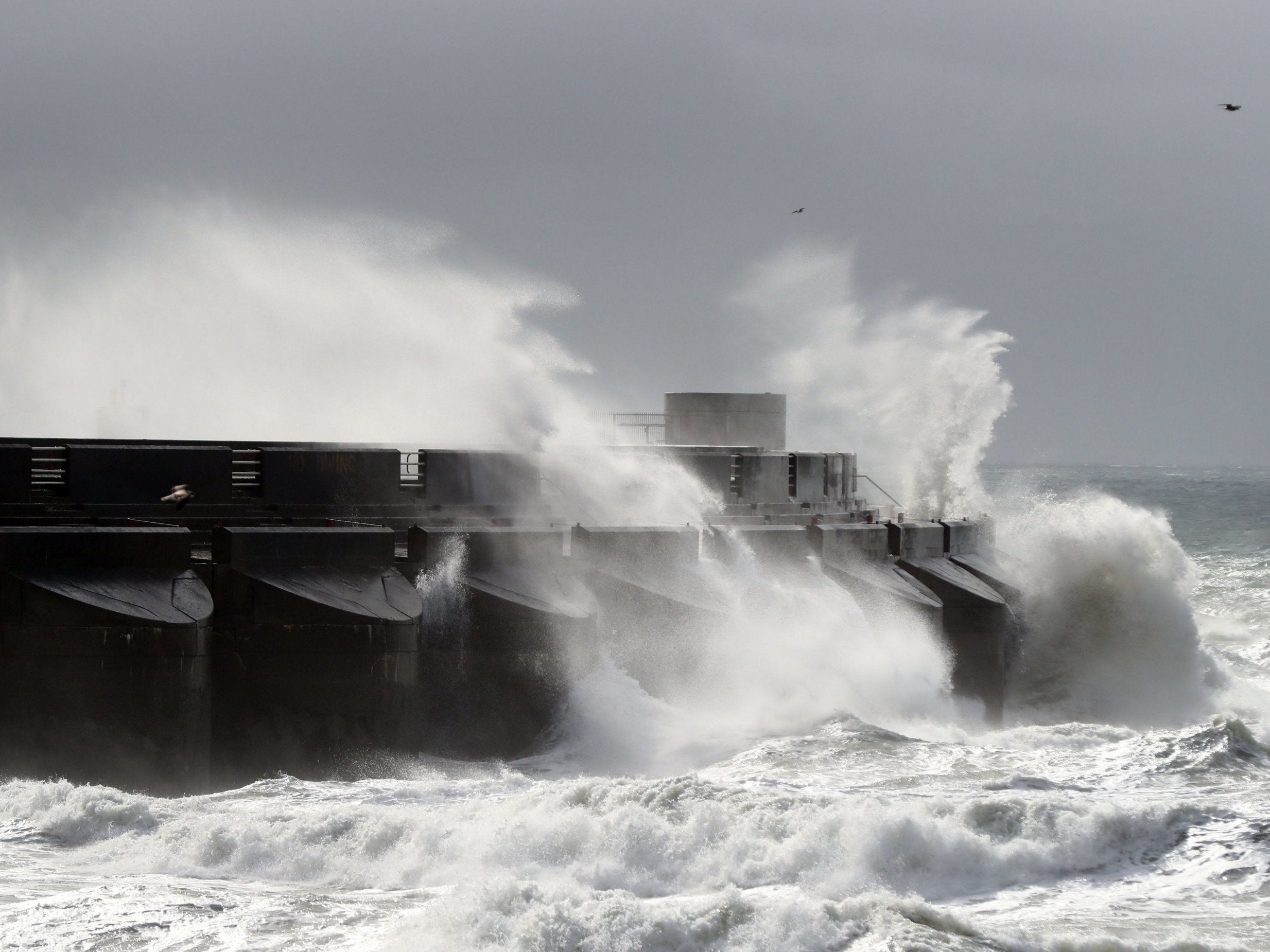 Waves crash over the marina wall in Brighton, East Sussex, as stormy weather arrives across the UK