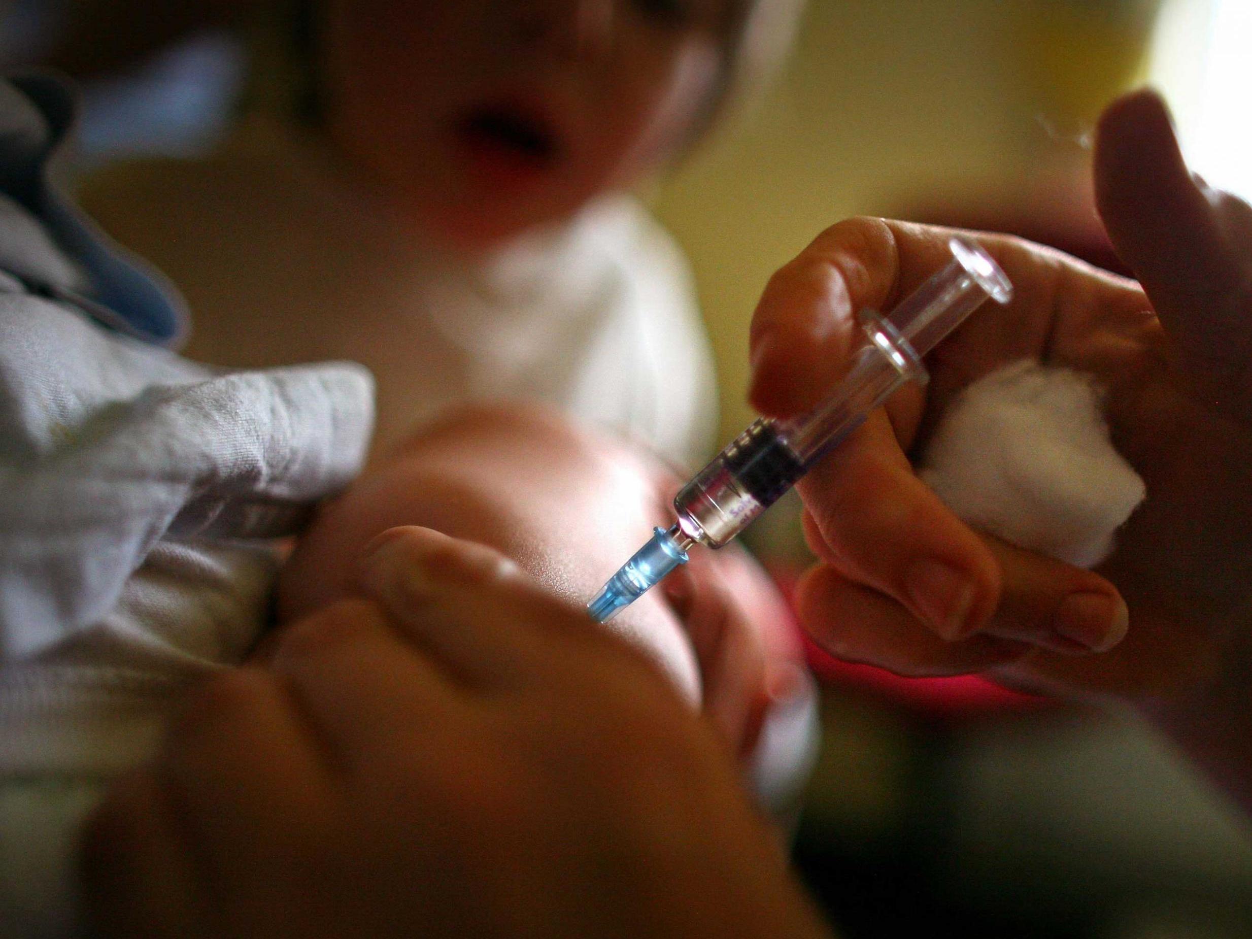 A young boy receives an immunisation jab
