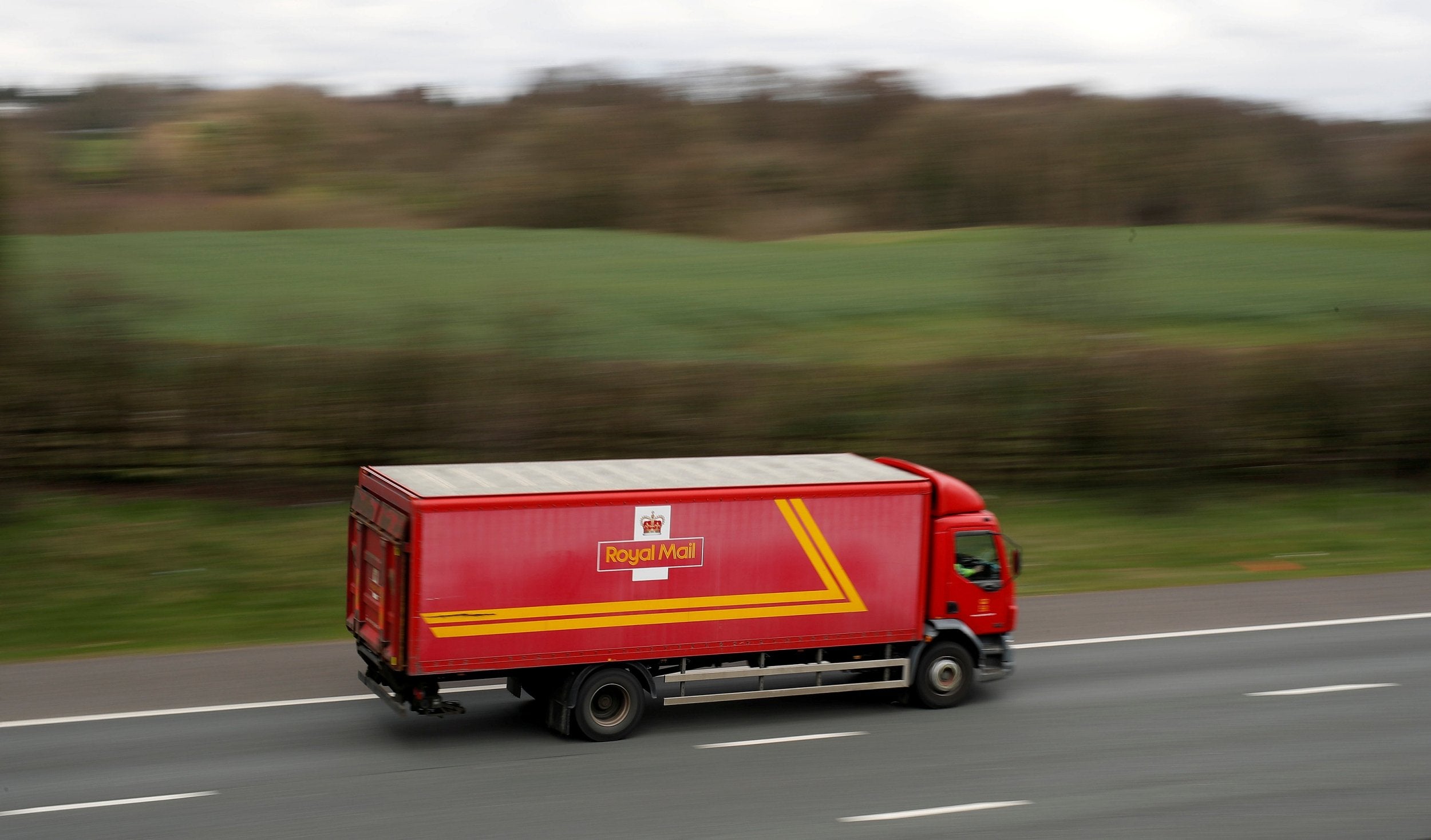 A Royal Mail truck on the move. But the company's earnings and share price are going backwards