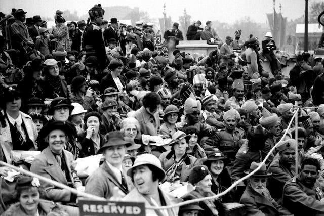 Crowds at the Queen Victoria Memorial in London celebrate the coronation of King George VI in 1937. But why were ordinary people so preoccupied with such events?