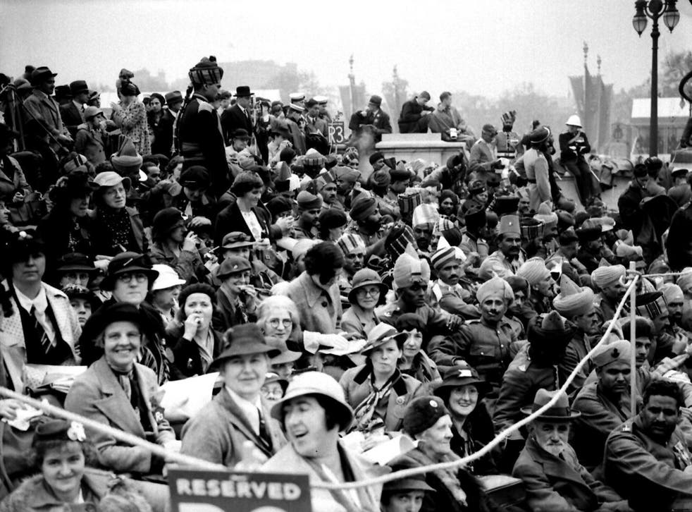 Crowds at the Queen Victoria Memorial in London celebrate the coronation of King George VI in 1937. But why were ordinary people so preoccupied with such events?
