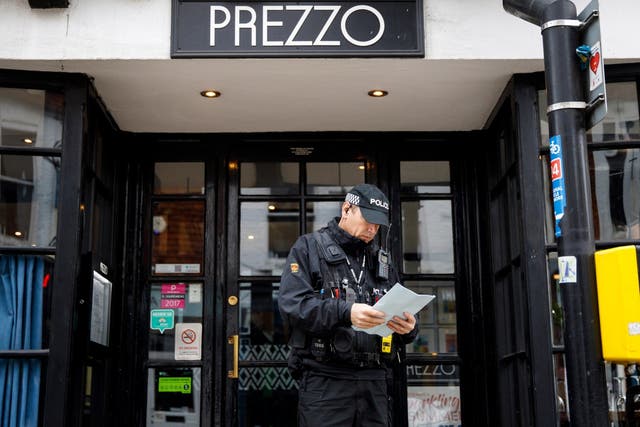 A police officer stands outside Prezzo restaurant in Salisbury, where a couple fell ill in unexplained circumstances