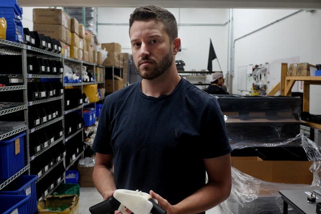 Cody Wilson with an example of a 3-D printed gun, called the 'Liberator', which his company Defence Distributed designed at his factory in Austin, Texas