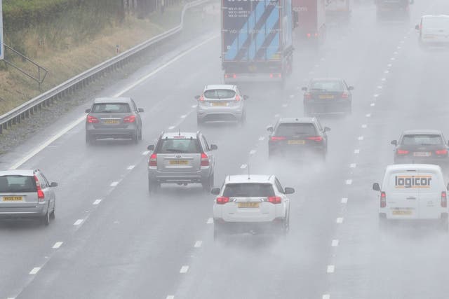 Cars travel through heavy rain on the M5 near Worcester