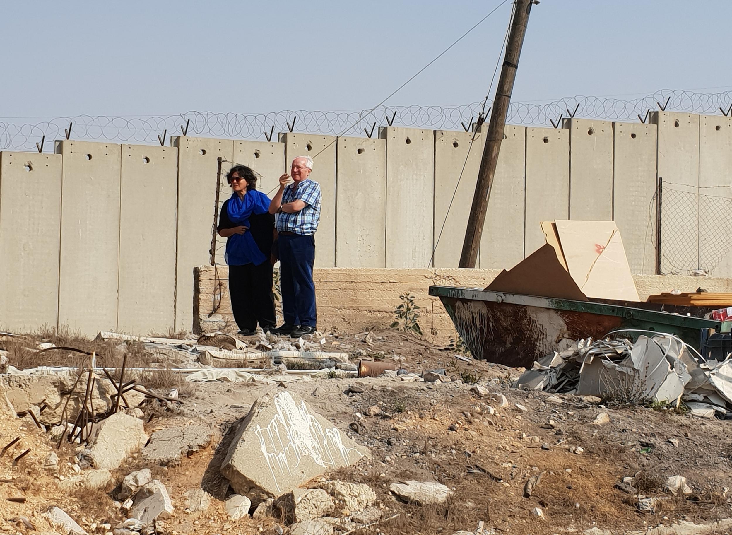 Robert Fisk and Israeli journalist Amira Hass walk alongside a section of 'The Wall' at the West Bank (Nelofer Pazira)
