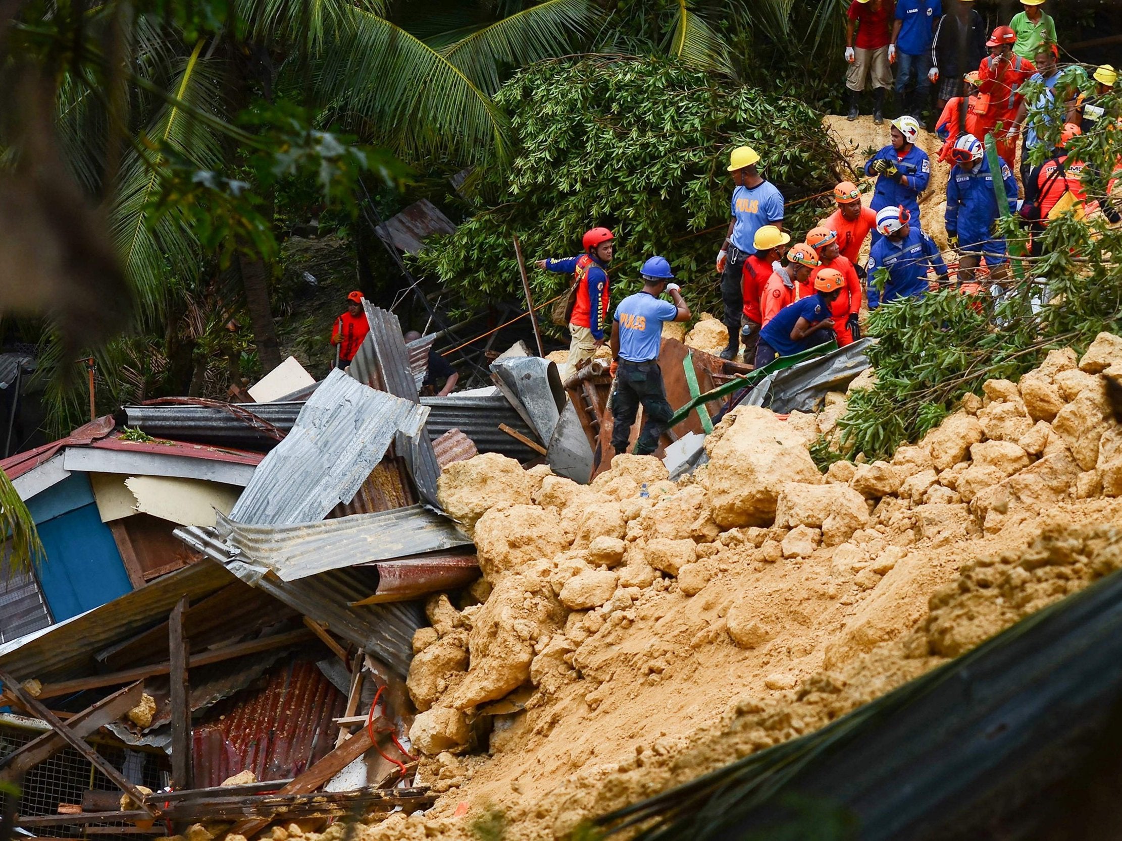 Rescuers search for survivors at the landslide site on the popular tourist island of Cebu