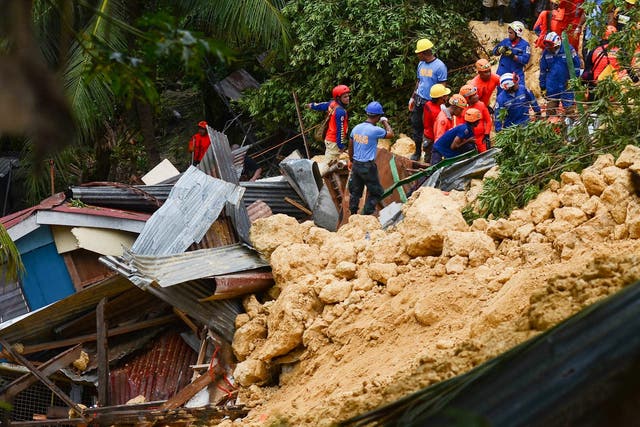 Rescuers search for survivors at the landslide site on the popular tourist island of Cebu