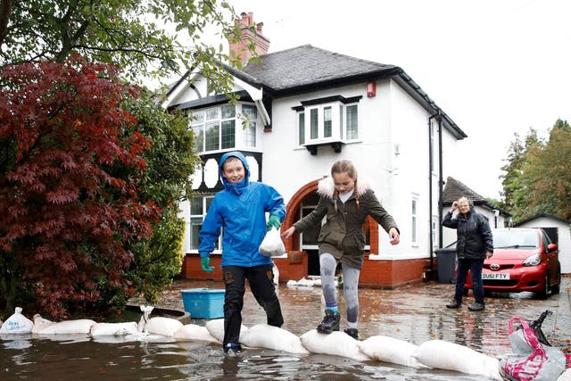 Residents sand bagged their houses as flooding hit Newcastle-under-Lyme, Staffordshire after Storm Bronagh battered it with rains.