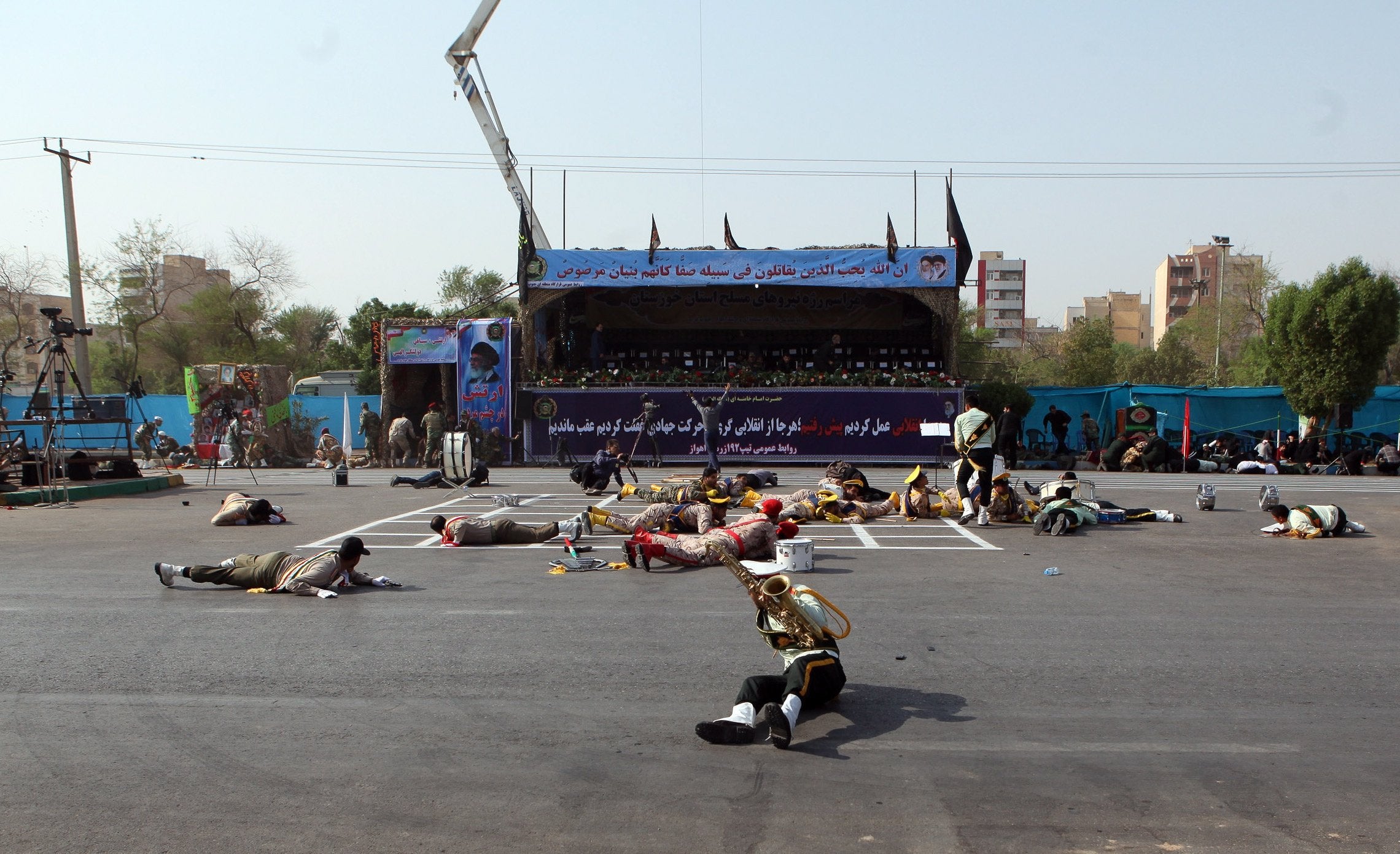 Iranian soldiers on the ground as a terror attack take place during a military parade in the city of Ahvaz