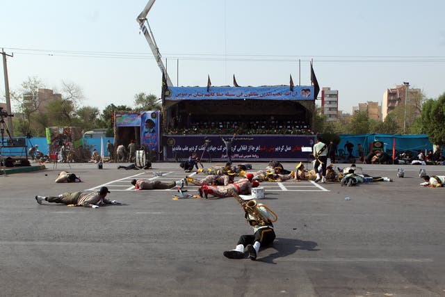 Iranian soldiers on the ground as a terror attack take place during a military parade in the city of Ahvaz