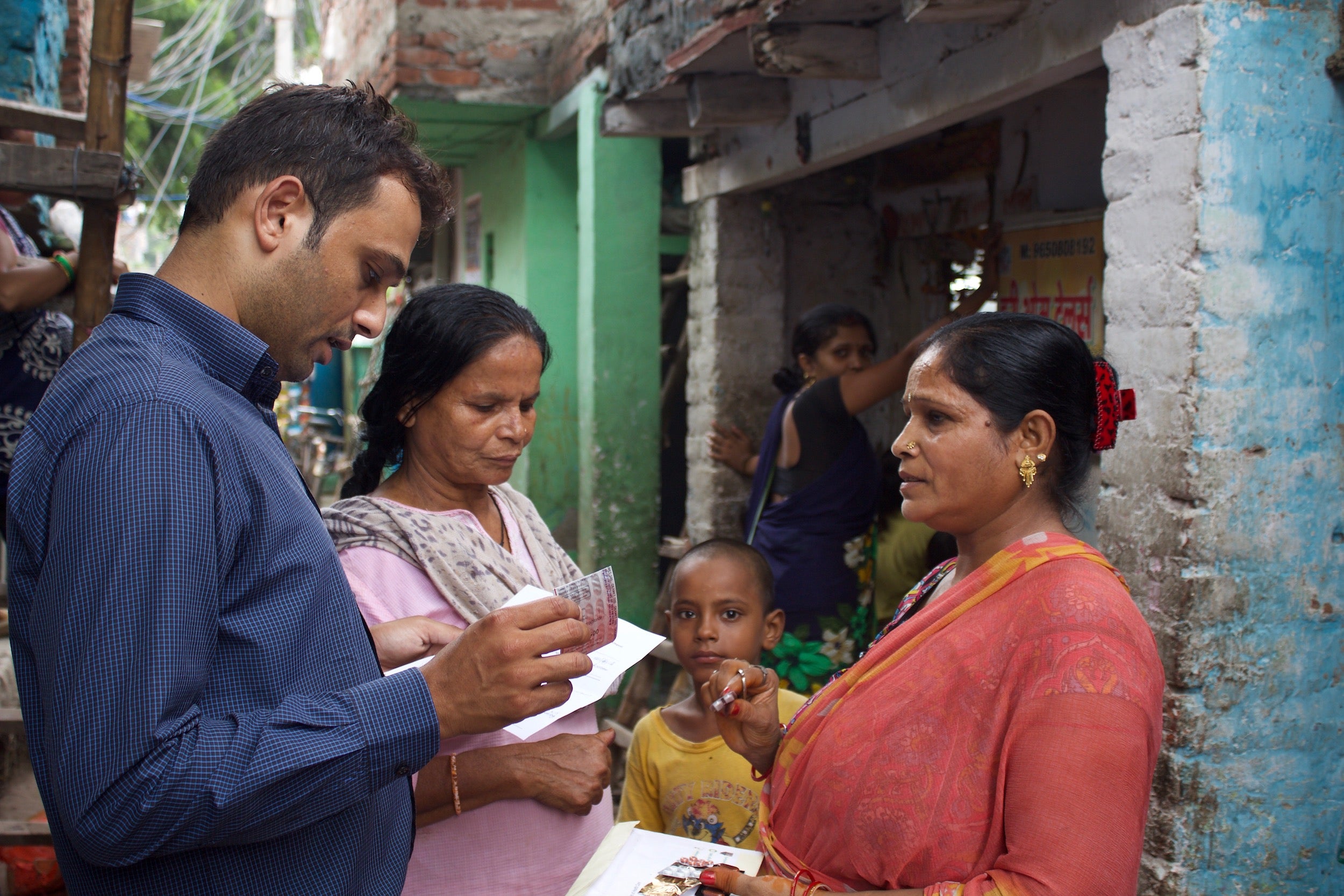 A member of the Smile Foundation team gives advice to Asha, a beneficiary, on how to take her medicine