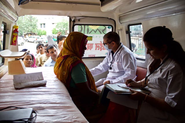 Smile Foundation's doctors treat patients in a mobile hospital, stepping in where India's underfunded public health system falls short