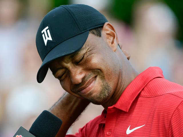 Tiger Woods tries to maintain his composure while getting choked up