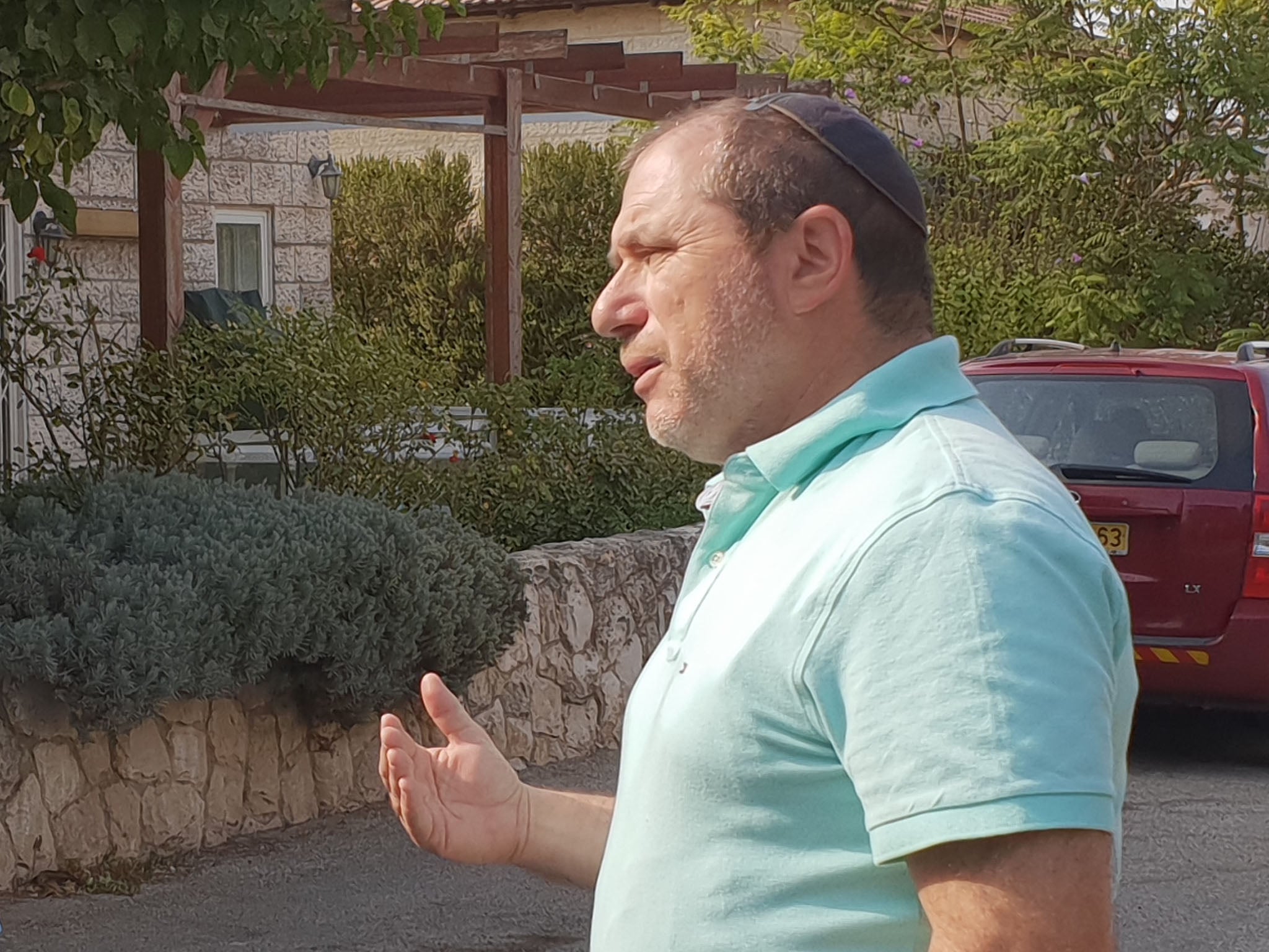 Silberstein stands outside his villa home
