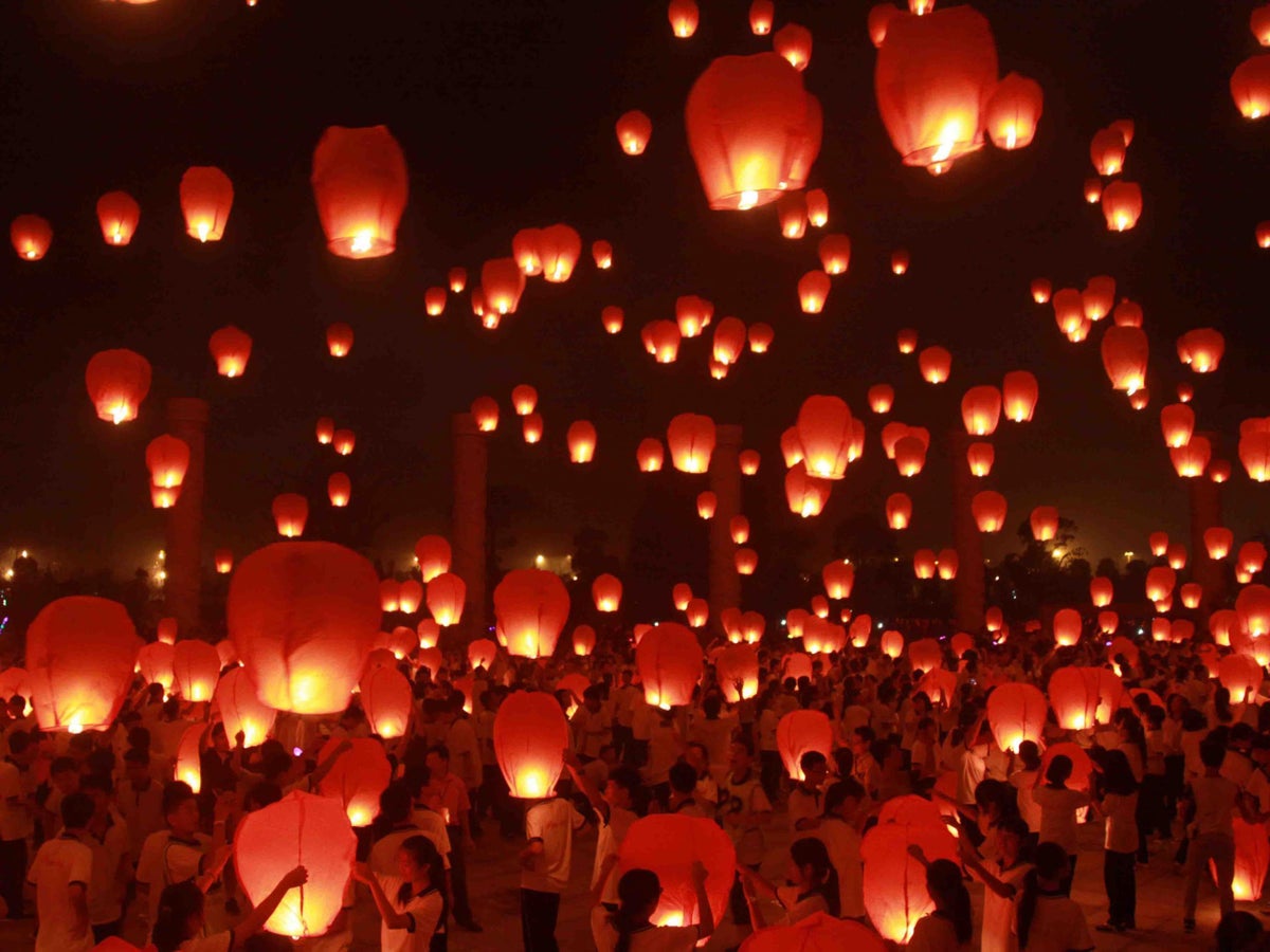 Red floating lanterns with candles and community