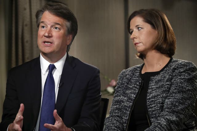 Brett Kavanaugh, with his wife Ashley Estes Kavanaugh, answers questions during a Fox News interview