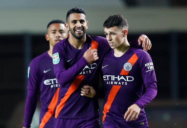 Manchester City's Riyad Mahrez celebrates scoring their second goal with Phil Foden