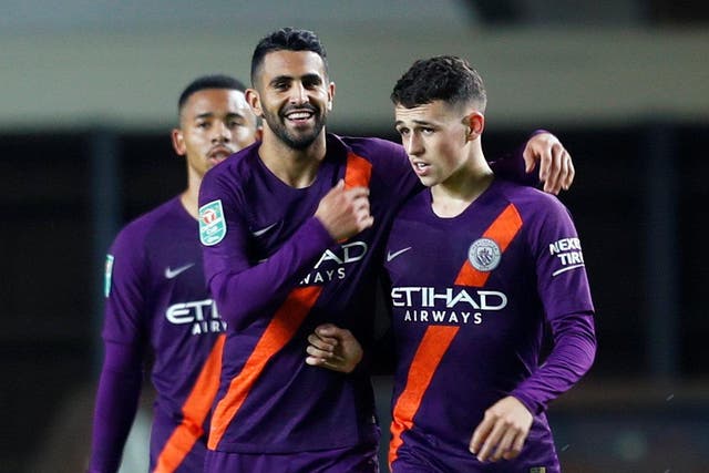 Manchester City's Riyad Mahrez celebrates scoring their second goal with Phil Foden
