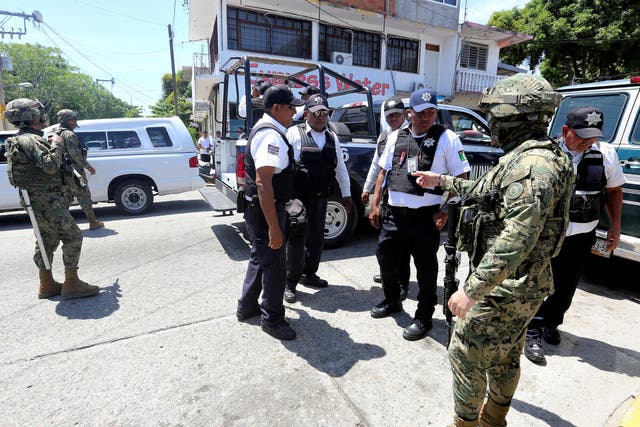Mexican marines escort municipal police officers disarmed and detained during an operation to check if they colluded with organised crime, in Acapulco, Mexico September 25, 2018