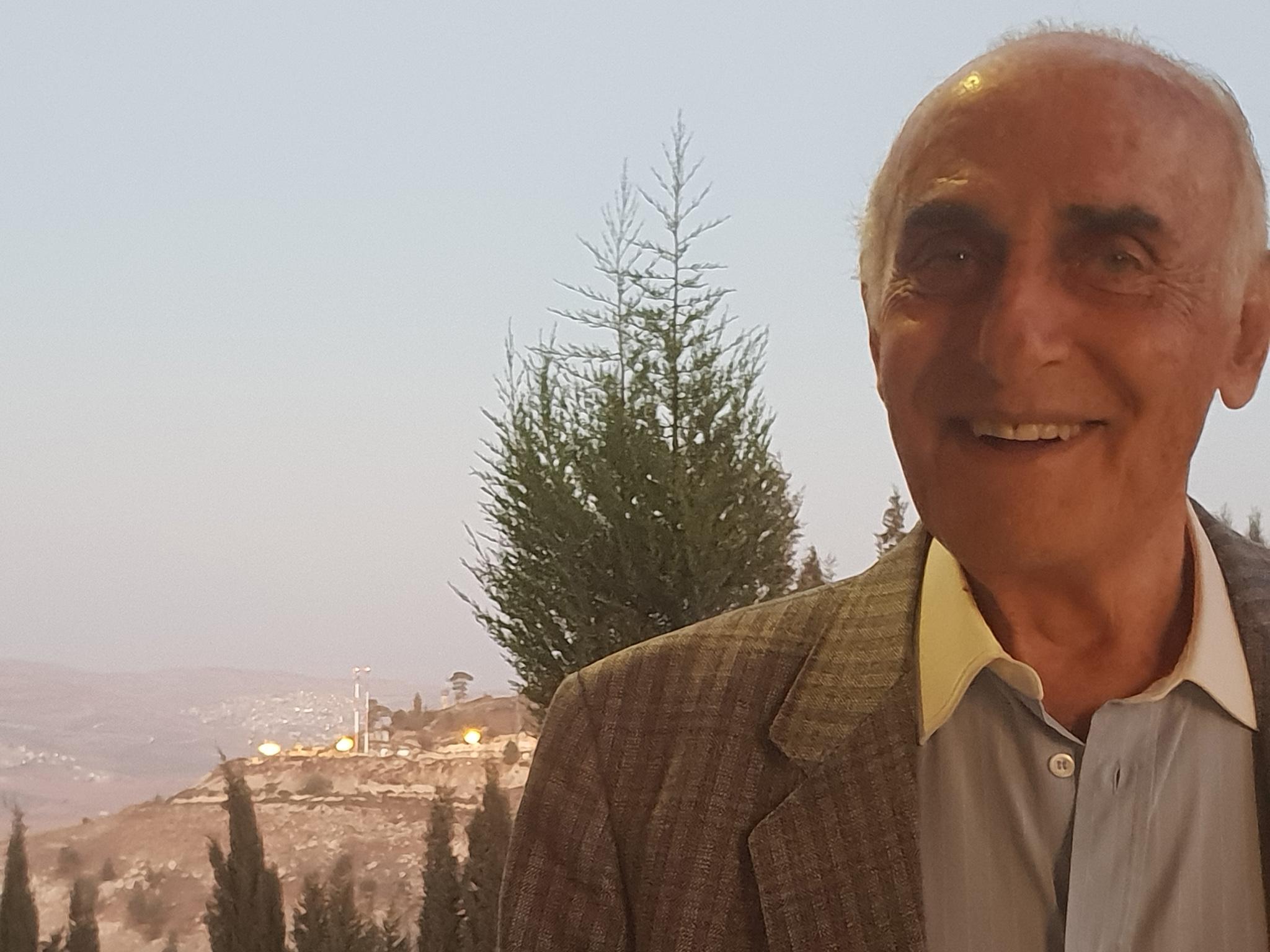 So far and yet so close: the lights of a nearby Jewish settlement shine over Munib Musri's shoulder as he stands on the edge of his vast palace of treasures near Nablus