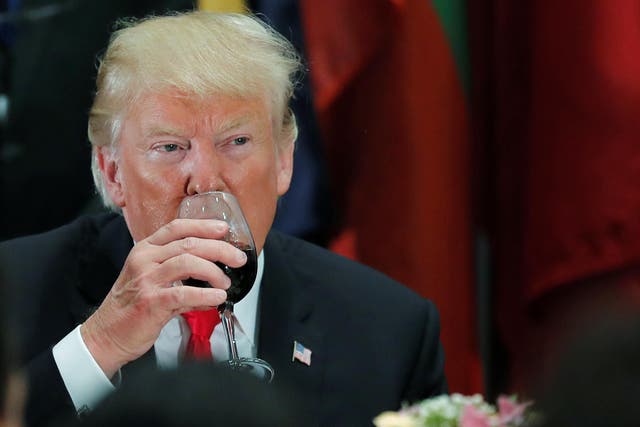 President Donald Trump sips Diet Coke from his wine glass after a toast during a luncheon for world leaders at the 73rd session of the United Nations General Assembly in New York, US, 25 September 2018