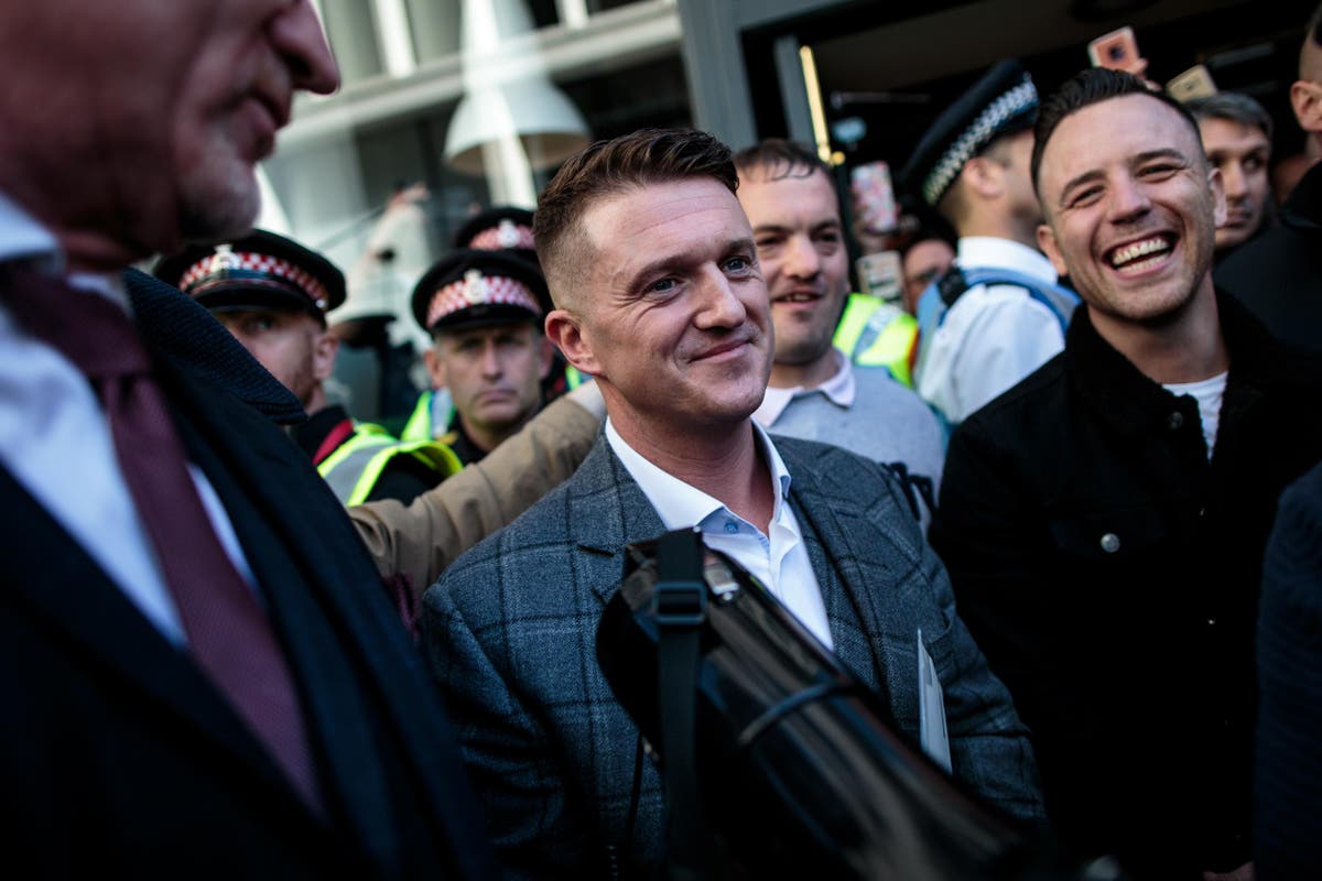 Tommy Robinson supporters hurl abuse at woman then rip away placard listing his previous crimes