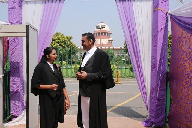 Lawyers for the successful petitioner stand outside the Supreme Court after the verdict in the adultery case in Delhi