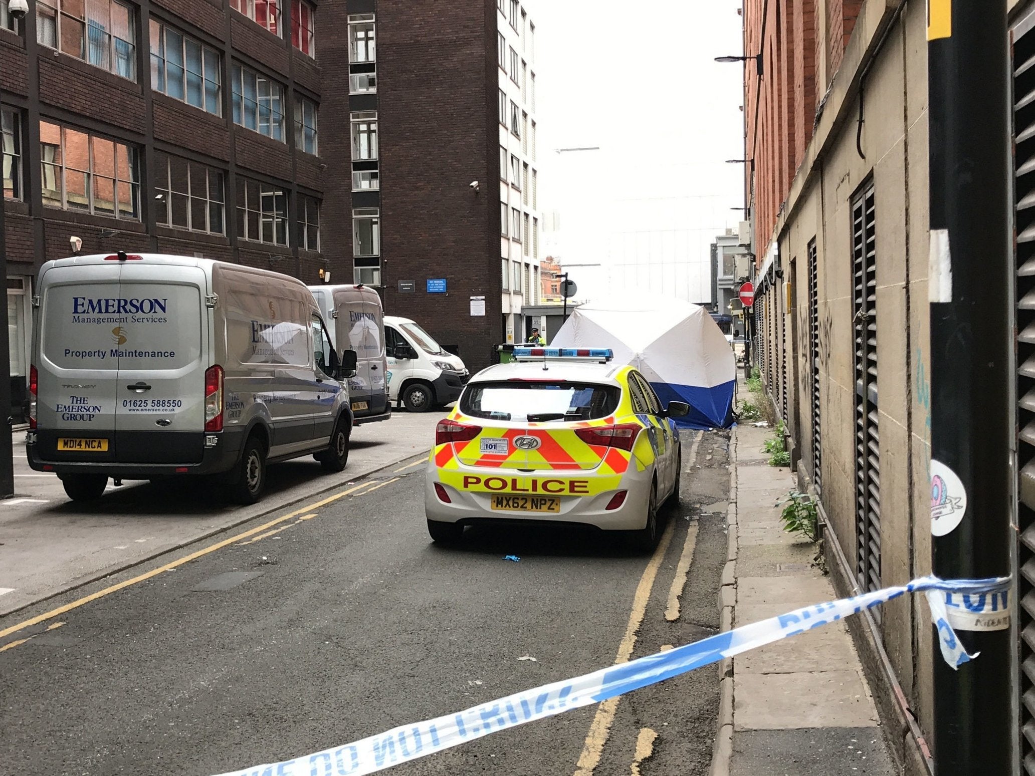 A police forensic tent outside the Britannia Hotel in Manchester city centre, where two men were found dead