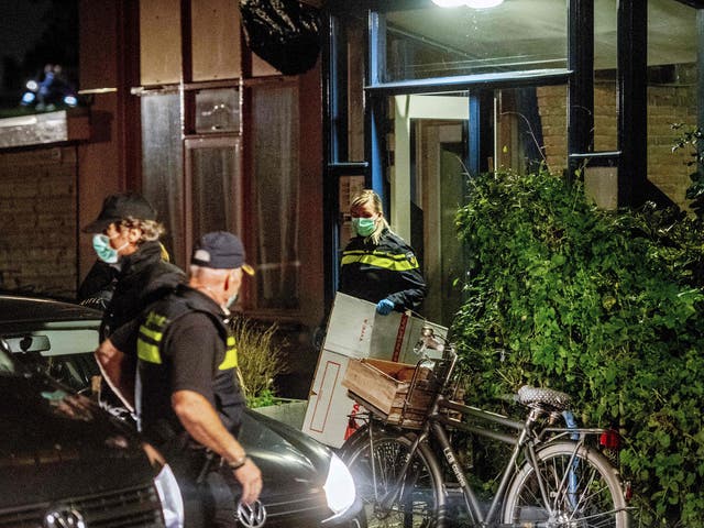 Police officers conduct an investigation at the residence of an alleged jihadist in Rotterdam