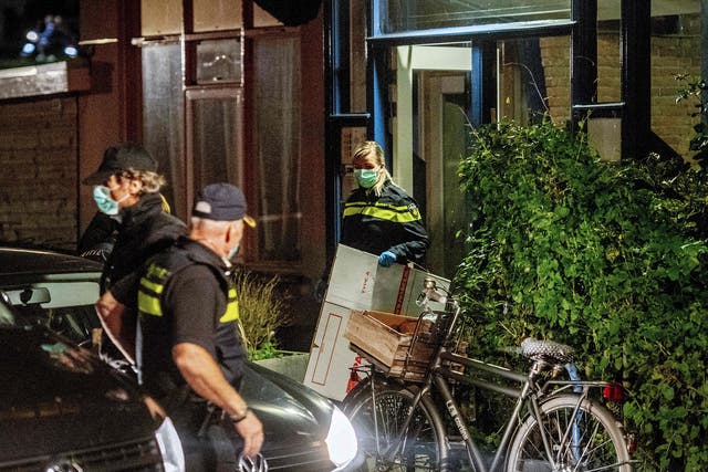 Police officers conduct an investigation at the residence of an alleged jihadist in Rotterdam