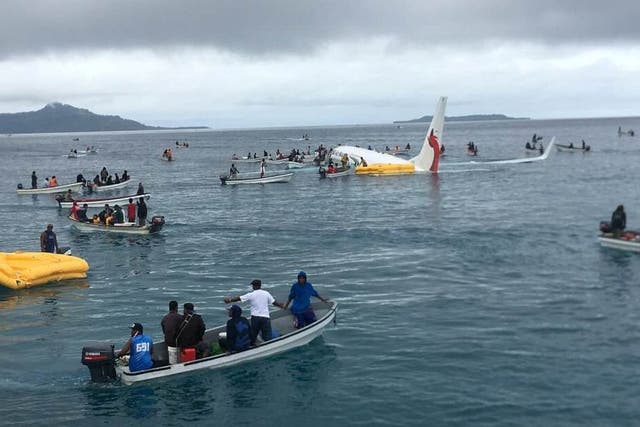 People are evacuated from an Air Niugini plane that crashed in the waters off Weno, Chuuk Island in Micronesia