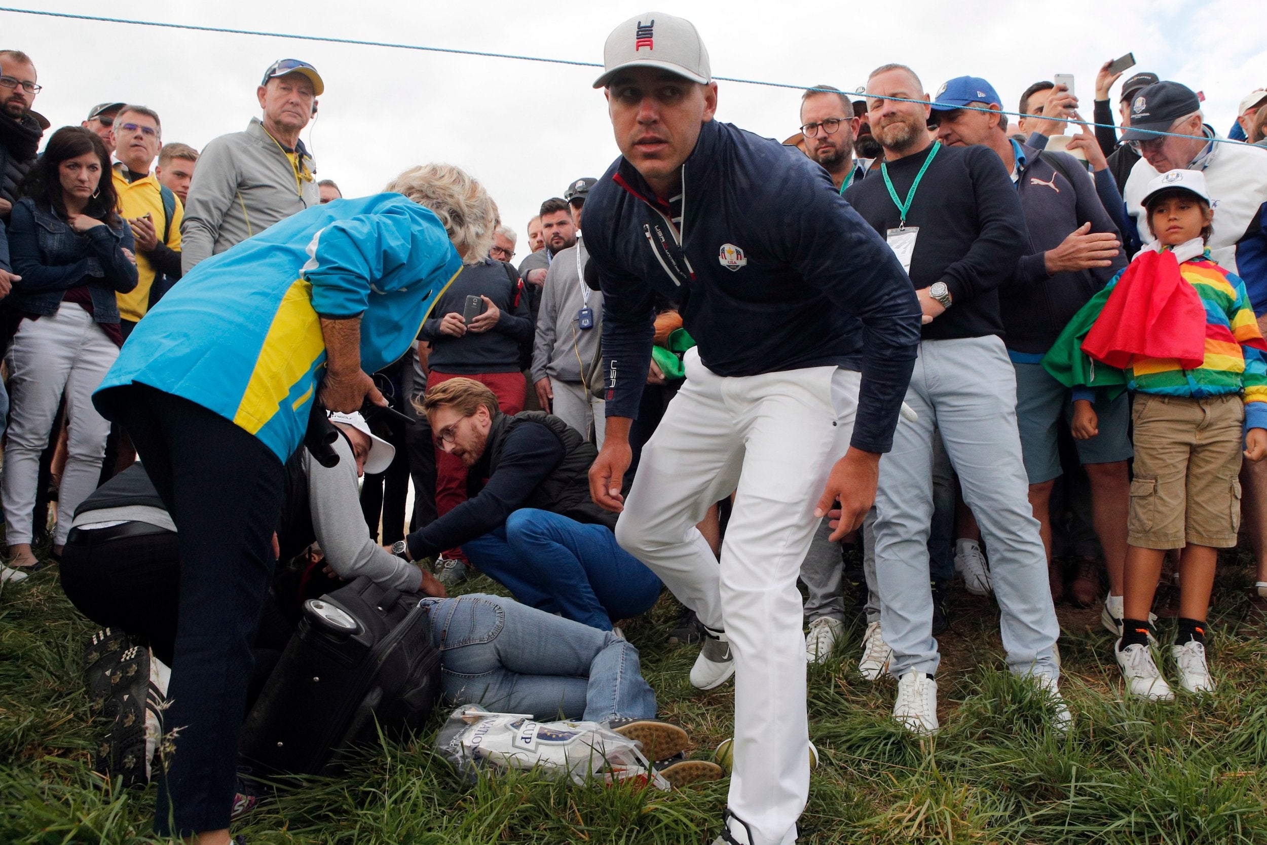 Corine Remande receives treatment after Brooks Koepka's drive hit her