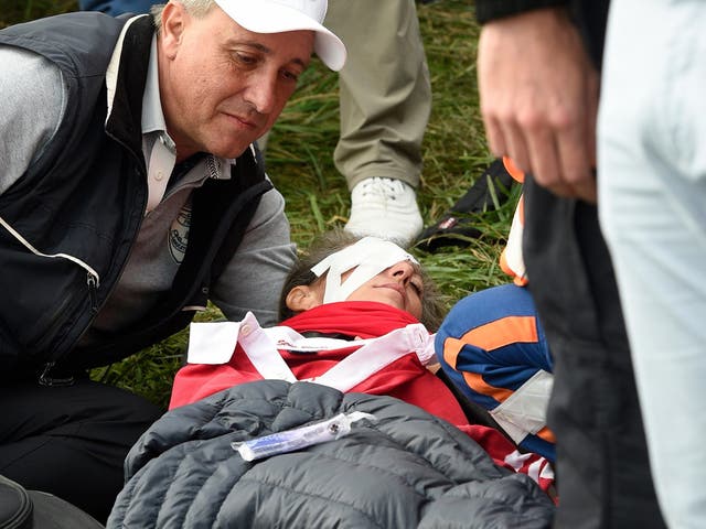 A patron receives medical treatment after being hit by Brooks Boepka's shot