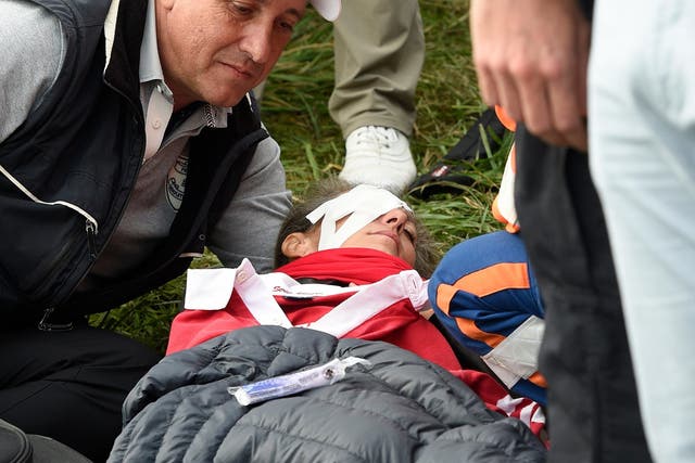 A patron receives medical treatment after being hit by Brooks Boepka's shot